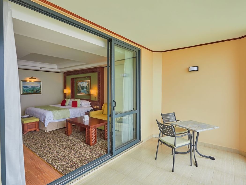 Balcony lounge area in King Deluxe Room at Goma Serena Hotel