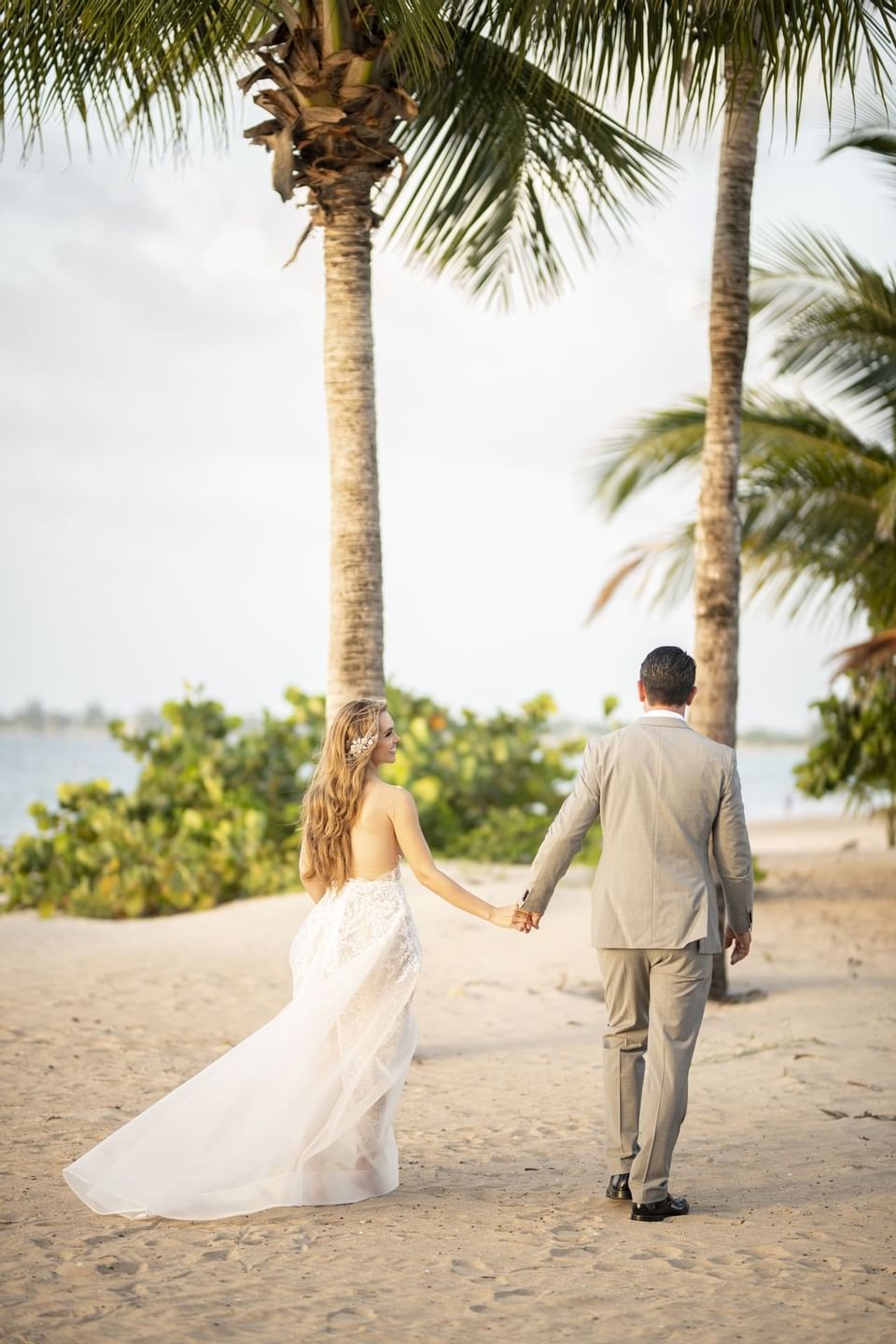 Bride & Groom posing by the beach at Isla Verde Weddings