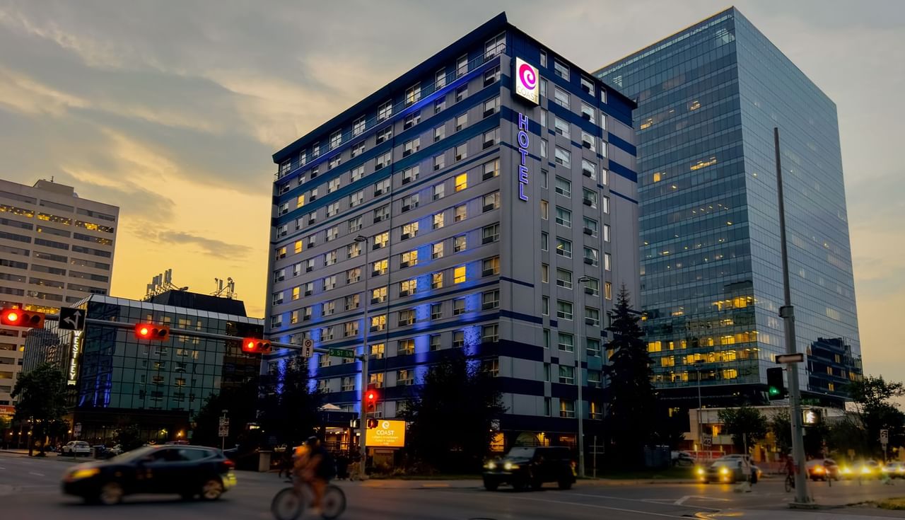 Exterior of Coast Calgary Downtown Hotel & Suites by APA during sunset