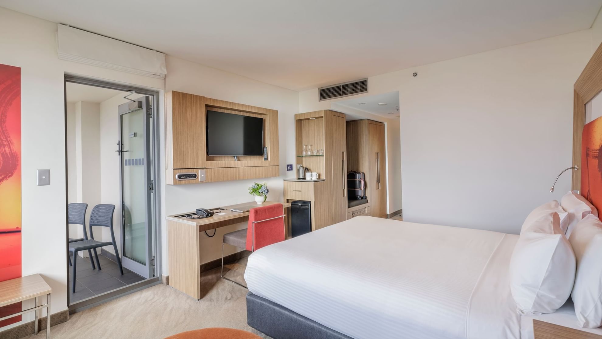 TV, work desk, and Coffee Station by the comfy bed in Balcony Room at Novotel Sydney Olympic Park