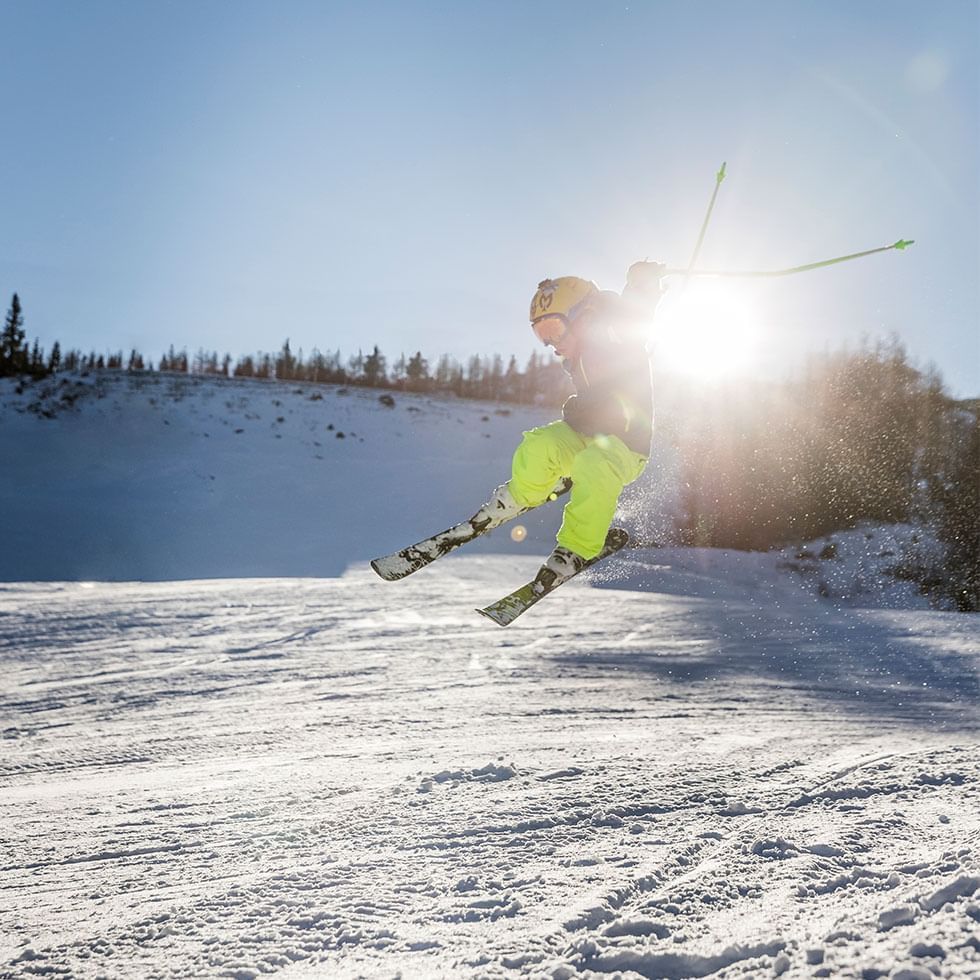 Skier jumping on the snow near Falkensteiner Hotels