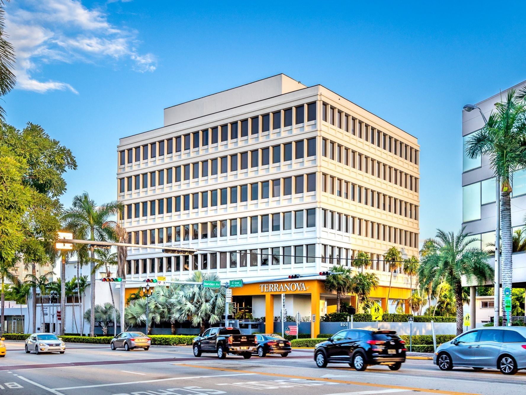 Terranova building with palm trees and cars on the 41st shopping street near Tradewinds Apartment Hotel