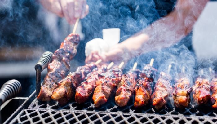 Pork on skewers cooked on barbecue grill at Rosen Inn Universal