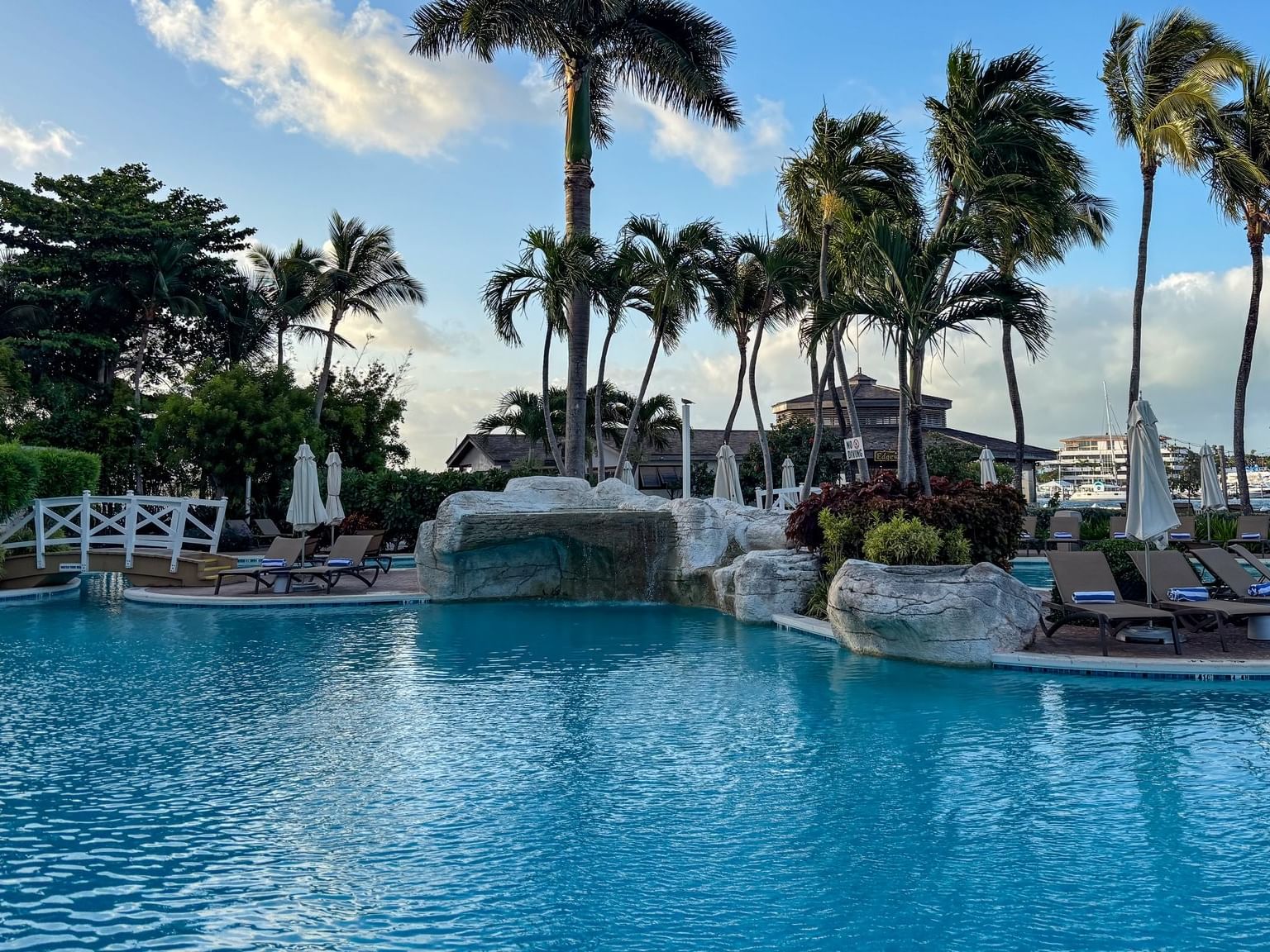 Main pool surrounded by palm trees and lounge chairs at Warwick Paradise Island Bahamas in Nassau