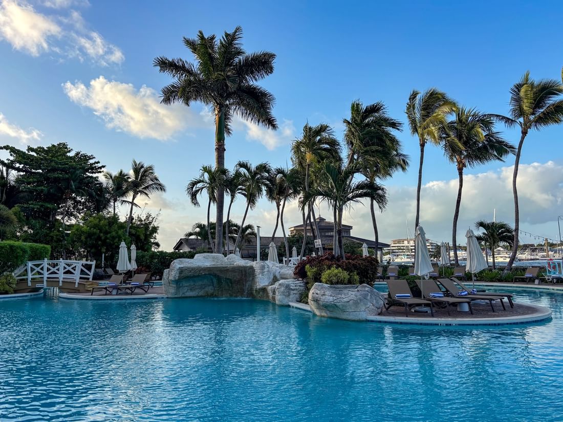 Main pool surrounded by palm trees and lounge chairs at Warwick Paradise Island Bahamas in Nassau