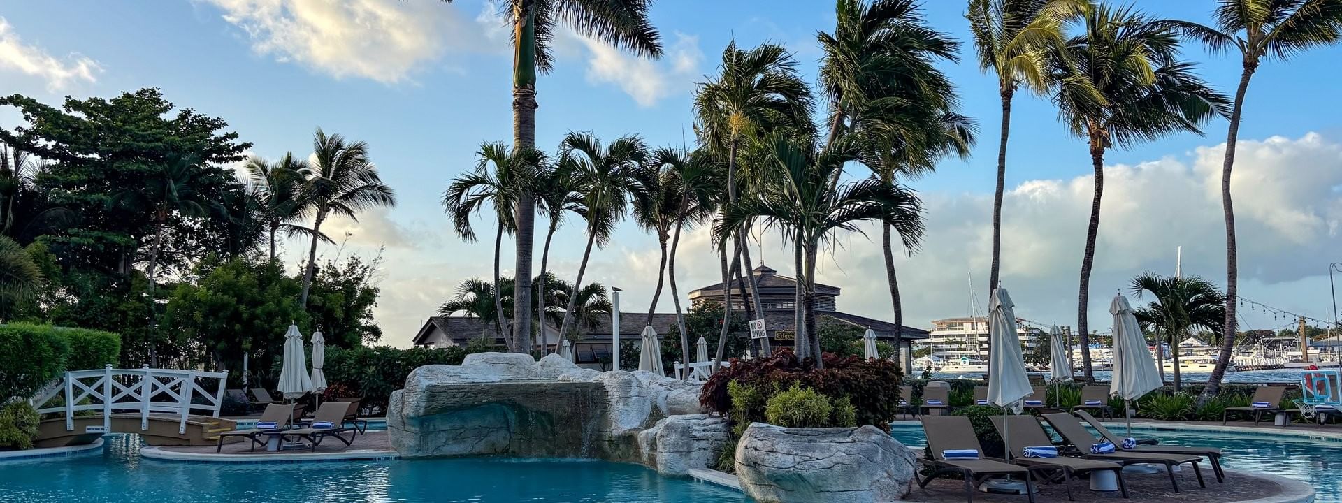 Main pool surrounded by palm trees and lounge chairs at Warwick Paradise Island Bahamas in Nassau