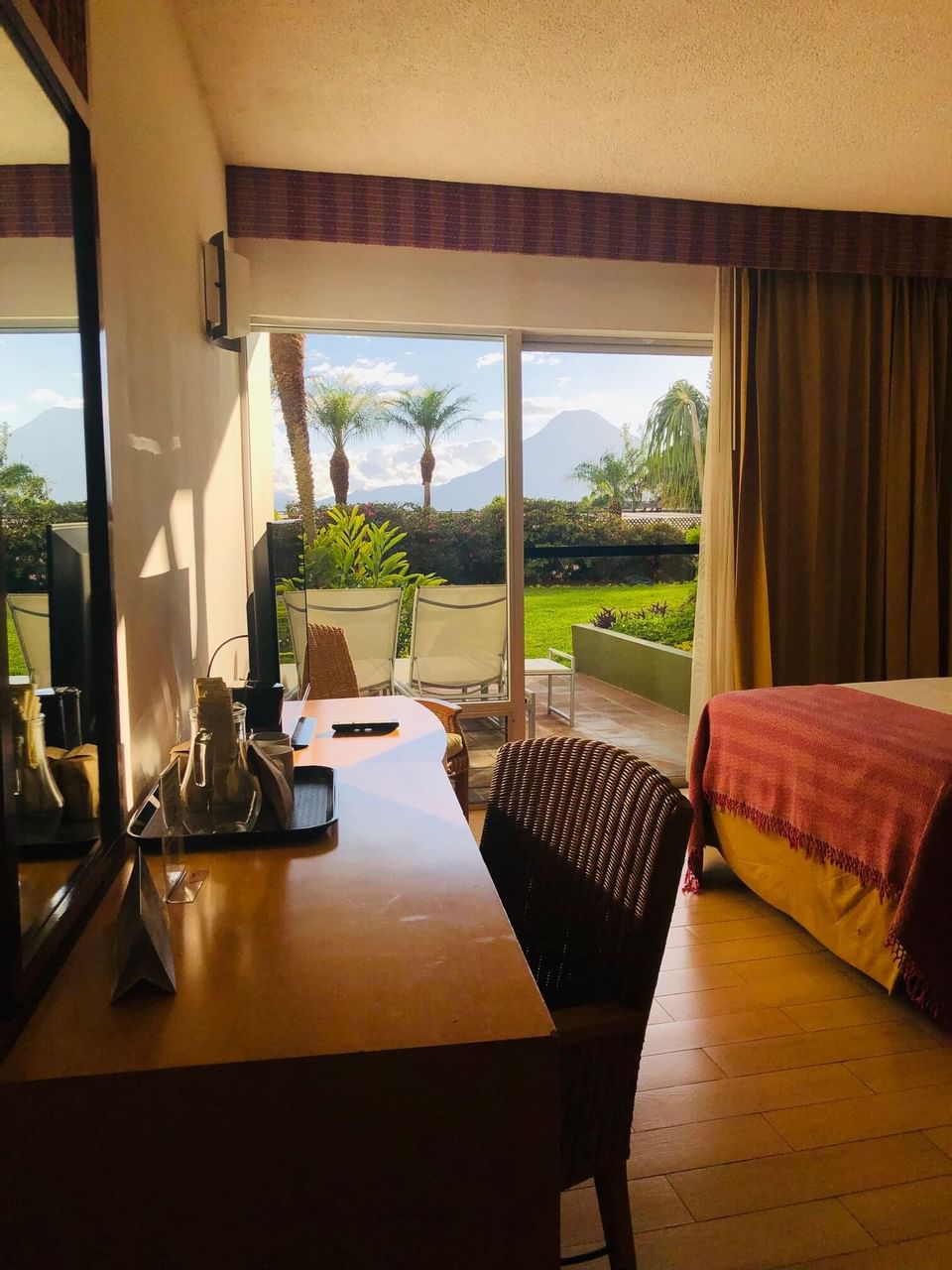 Coffee tray on a work desk by the bed with a patio lounge at Porta Hotel del Lago