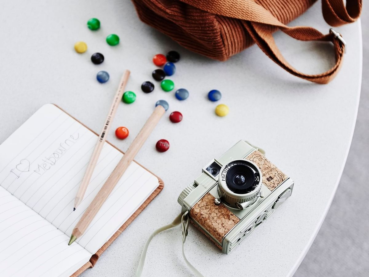Camera & book on a table in Minibar at Crown Hotels Group