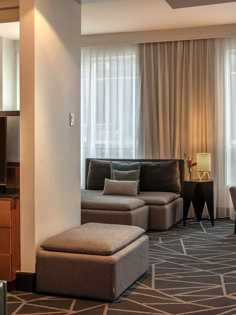 TV facing the bed with a separate living area in Premium Loft Suite at Warwick Le Crystal Montreal