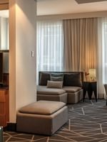 TV facing the bed with a separate living area in Premium Loft Suite at Warwick Le Crystal Montreal
