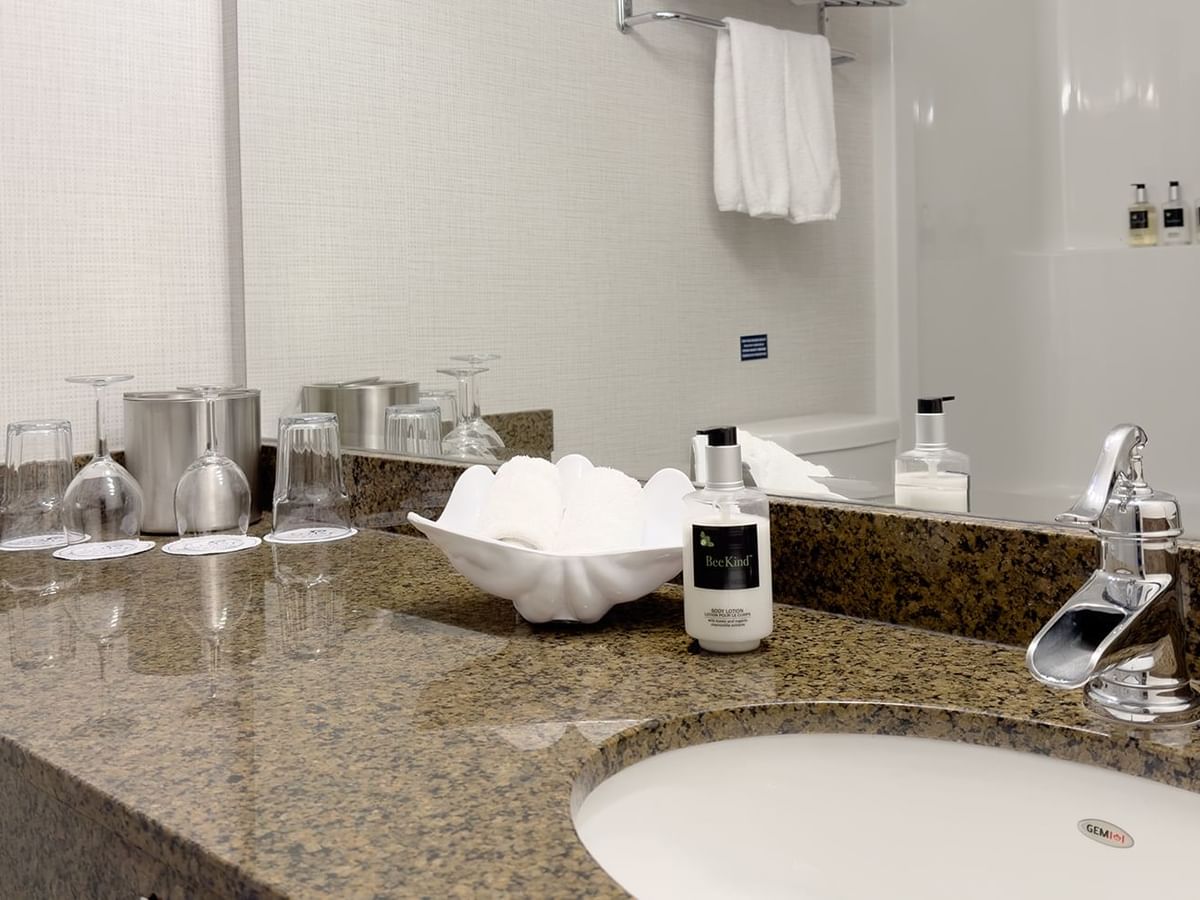 Washroom with sink, soap, and towels