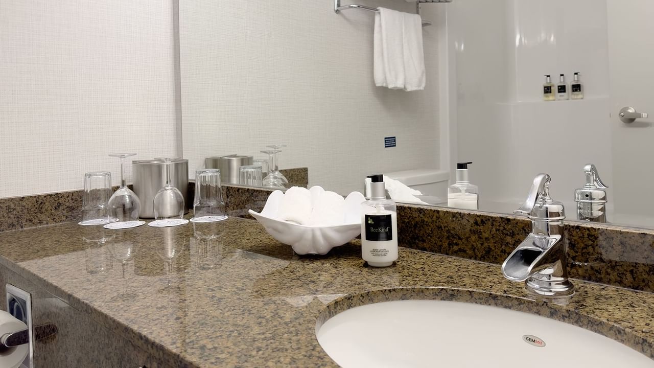 Washroom with sink, soap, and towels