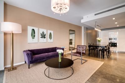 living room with purple velvet sofa and round coffee table