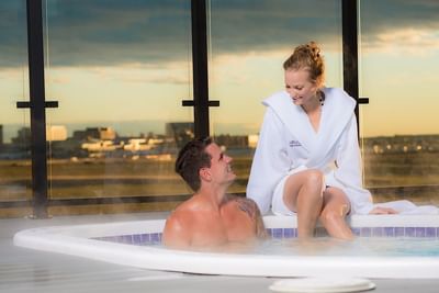 Couple in a hot bathtub at Hotel Clique Calgary Airport