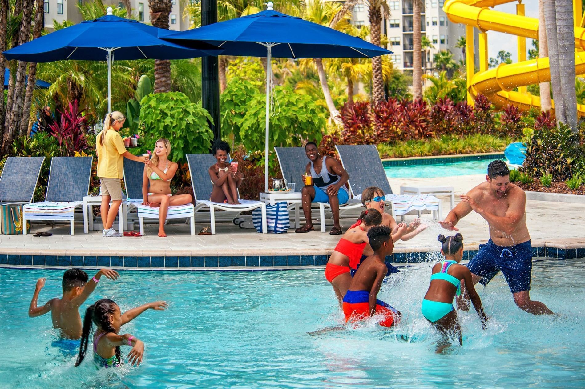 Children having fun in a resort pool, splashing water and playing games at Surfari Water Park Resort