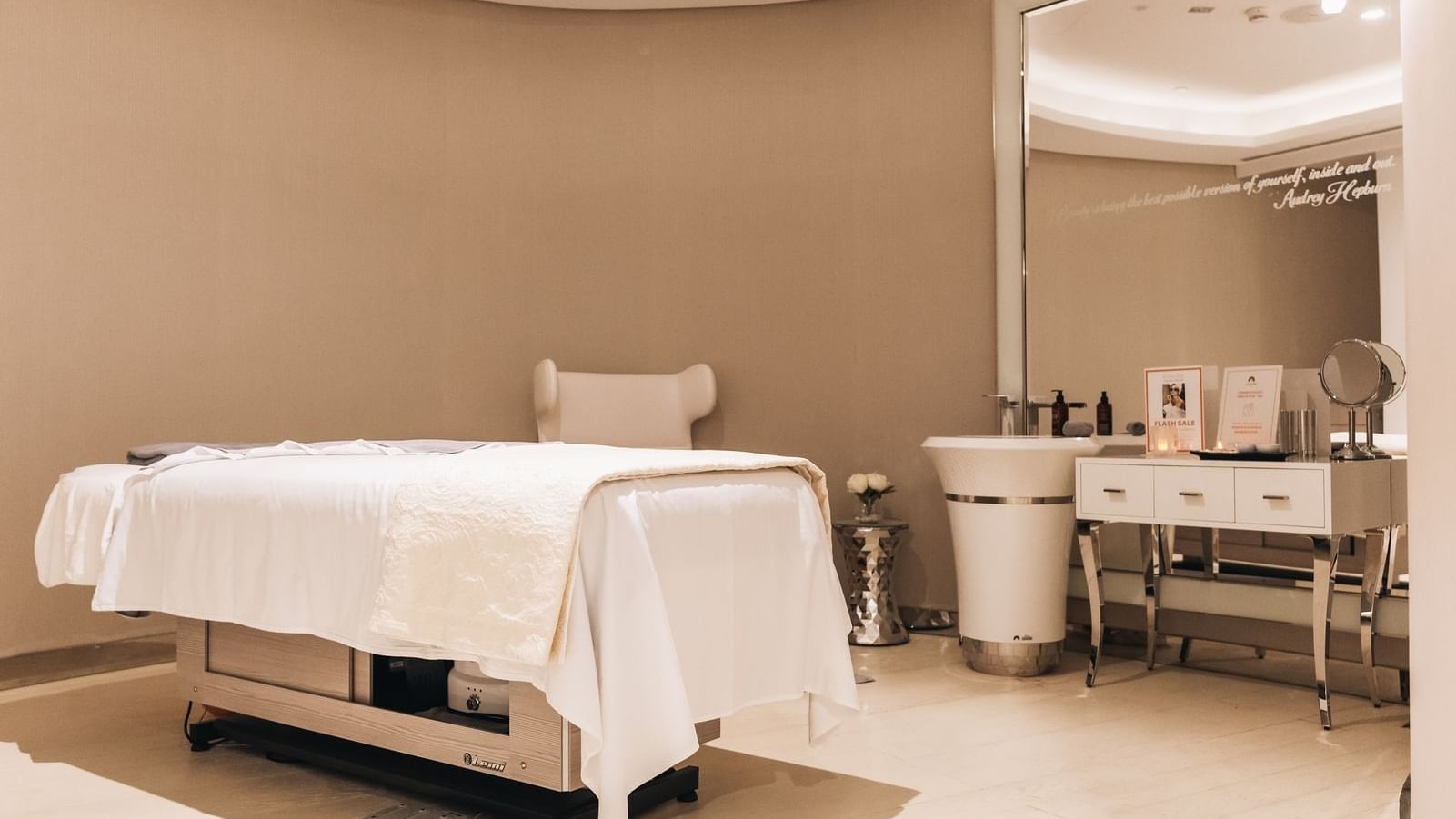Serene massage room at Pause Spa with a clean massage table, sink, and large mirror at Paramount Hotel Dubai