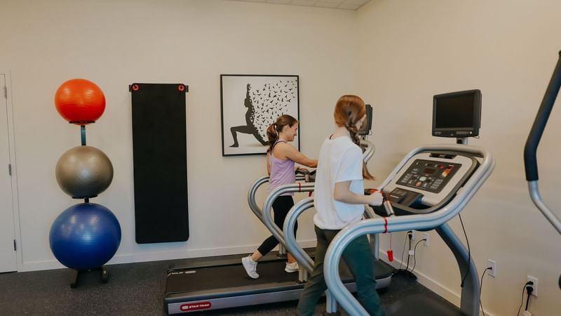 Girls on treadmill in fitness center at The Lodge 30A