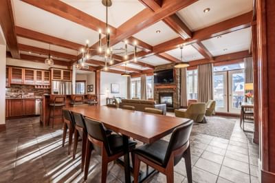 Spacious living room with dining table and loungers in Four Bedroom Penthouse Suite at Blackstone Mountain Lodge
