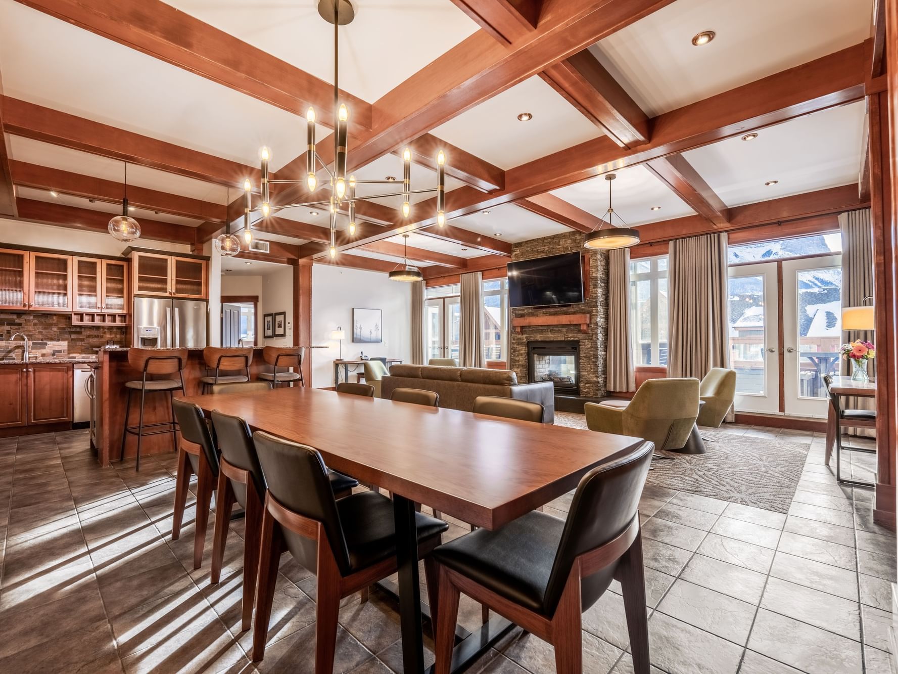 Spacious living room with dining table and loungers in Four Bedroom Penthouse Suite at Blackstone Mountain Lodge