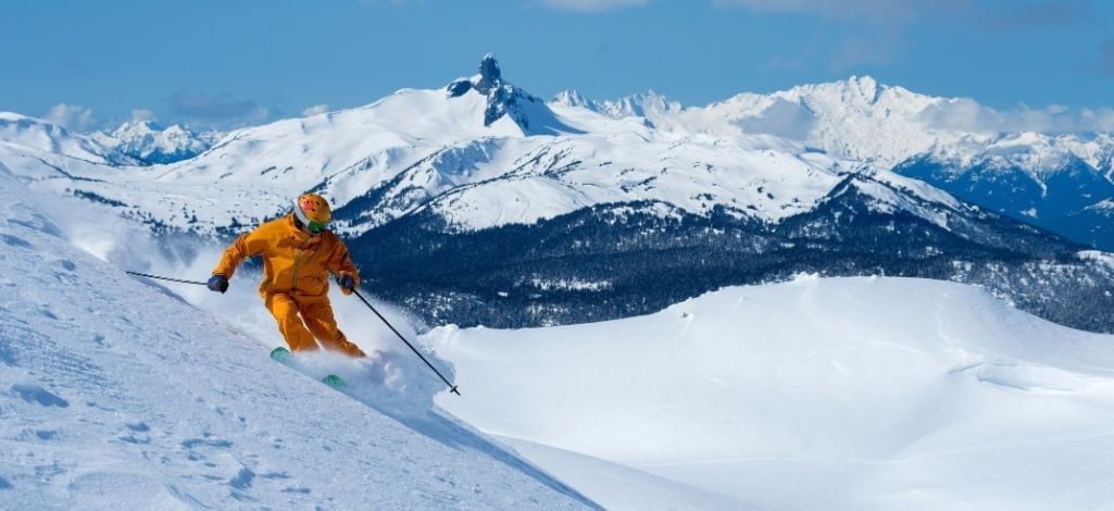 January in Whistler skier enjoying fresh snow and wide open alpine runs.