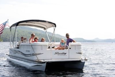 People enjoying a Pontoon boat ride on Schroon Lake Marina near The Lodge at Schroon Lake