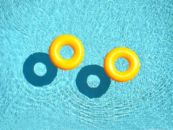 Top view of floats on an outdoor pool at Trianon Bonita Bay