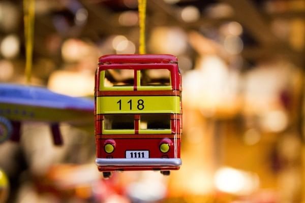 Miniature red double-decker bus toy hanging with blurred background at Lake Buena Vista Resort Village & Spa