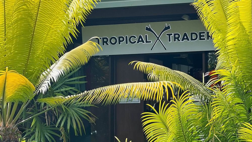 Tropical Trader shop entrance with lush greenery at The Naviti Resort in Korolevu.