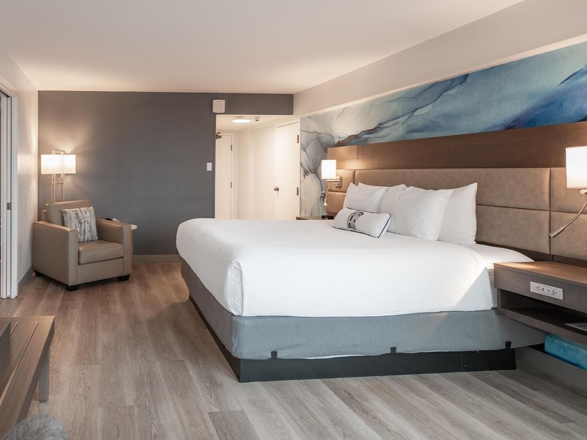 King bed, couch, and desk in Coast Premium King One Bedroom Suite at Coast Bastion Hotel in Nanaimo.