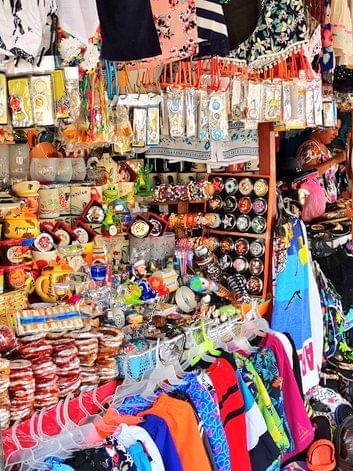 Shops with colorful items at Artisan Market near Mundo Imperial