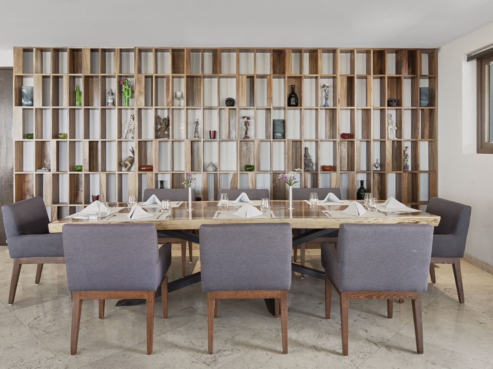 MAI restaurant dining table by an ornament shelf, La Colección