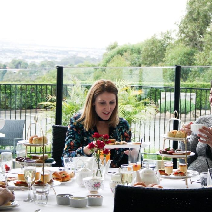 Women having afternoon tea at Mercure Charlestown.