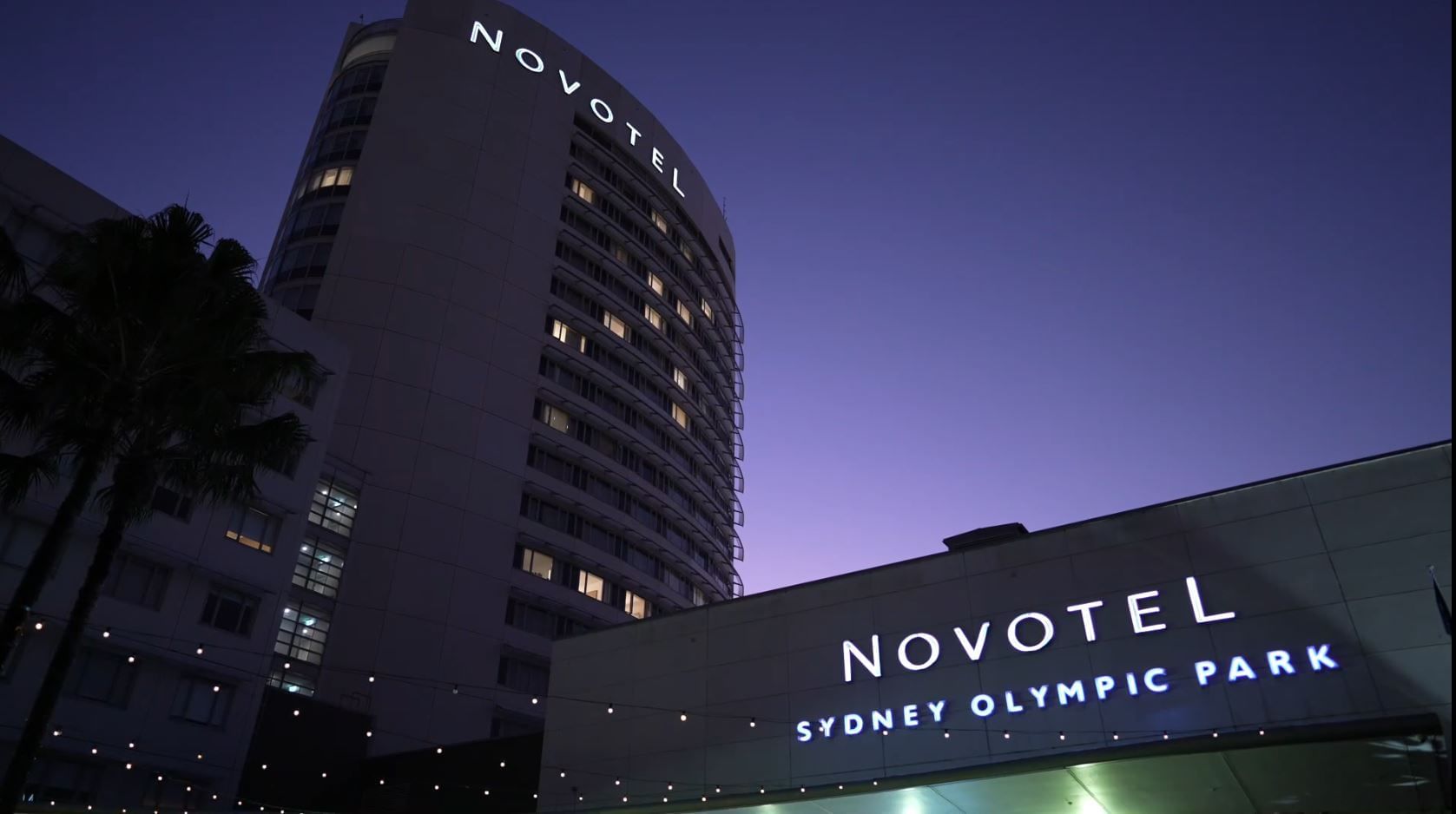 Exterior view of Novotel Sydney Olympic Park at night