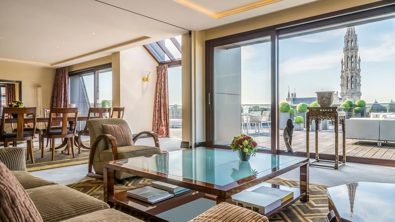 Dining and living area with city view in Grand Place Suite at Warwick Brussels