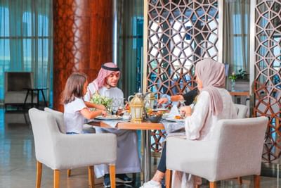 A family dining at the Seasons Restaurant in Bay La Sun Hotel & Marina