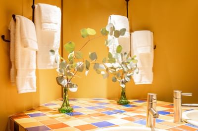 Bathroom vanity with towel rack in King Premiere Sante Fe at Retro Suites Hotel