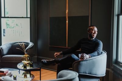 Man looking the outside through the window in lobby at The Stonebreaker Hotel