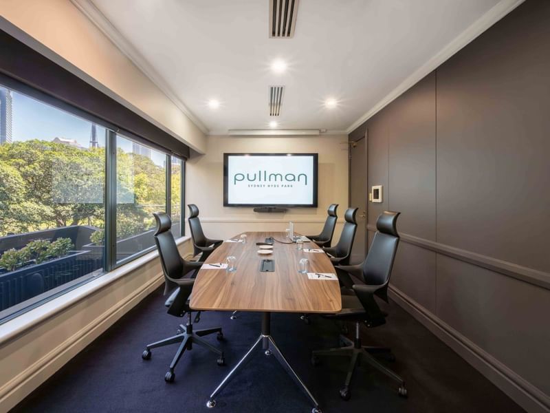 Boardroom set-up with TV in Busby Room at Pullman Sydney Hyde Park