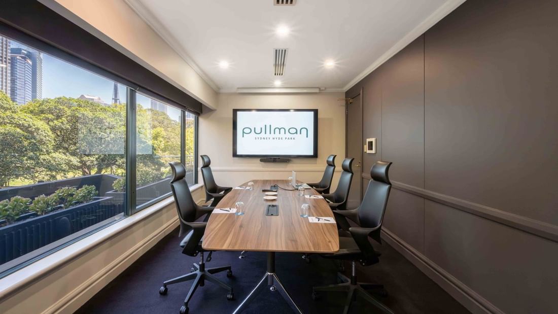 Boardroom set-up with TV in Busby Room at Pullman Sydney Hyde Park