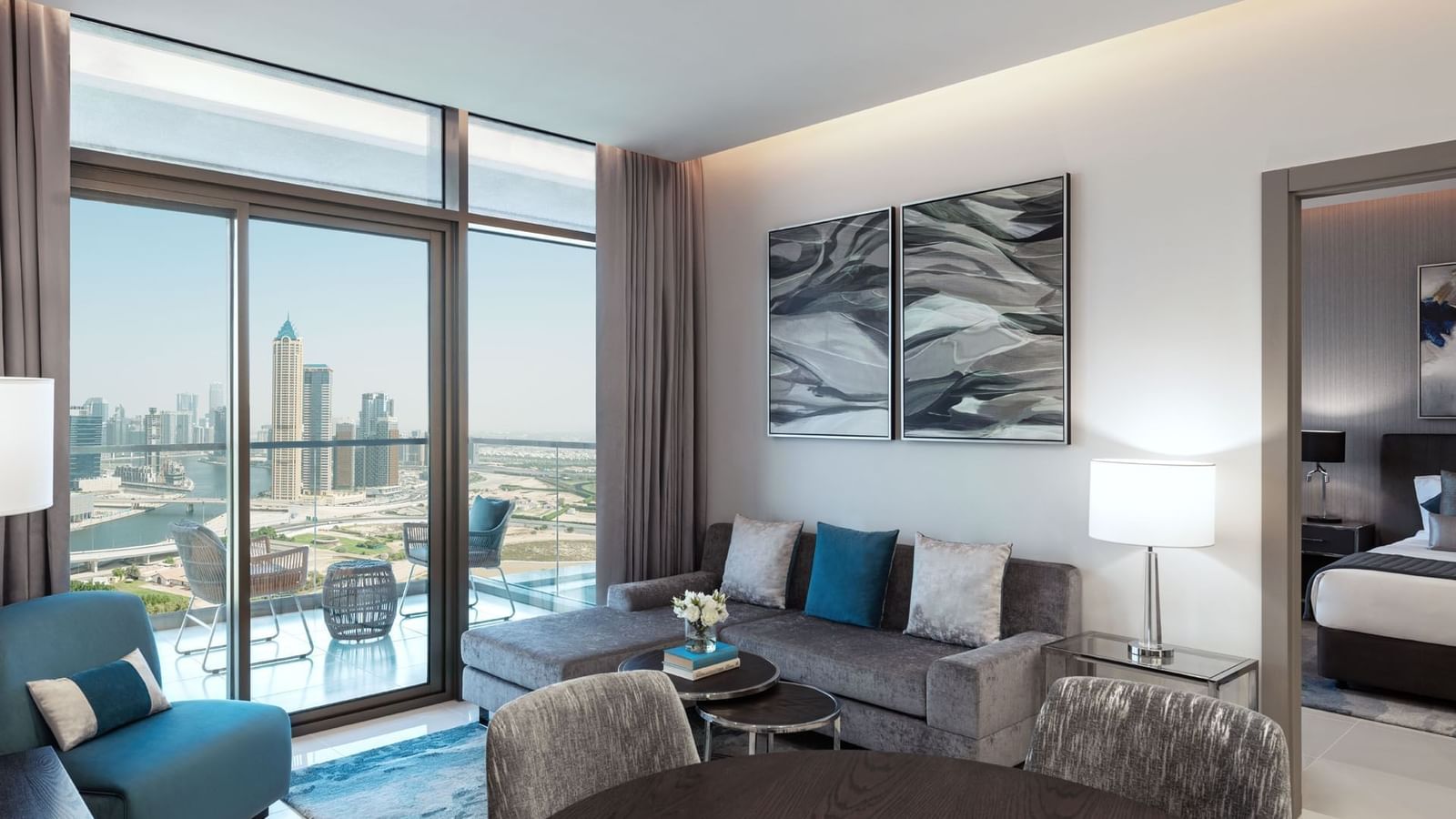 Cozy sofa with a city view in Two Bedroom living area & balcony at DAMAC Maison Aykon City