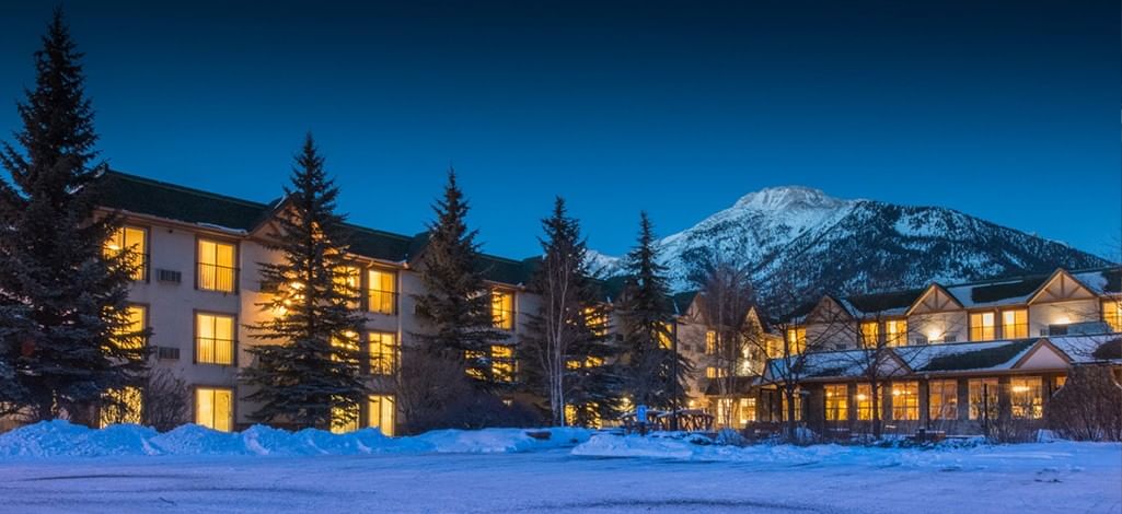 A hotel in Canmore is lit up on a cold, snowy night.