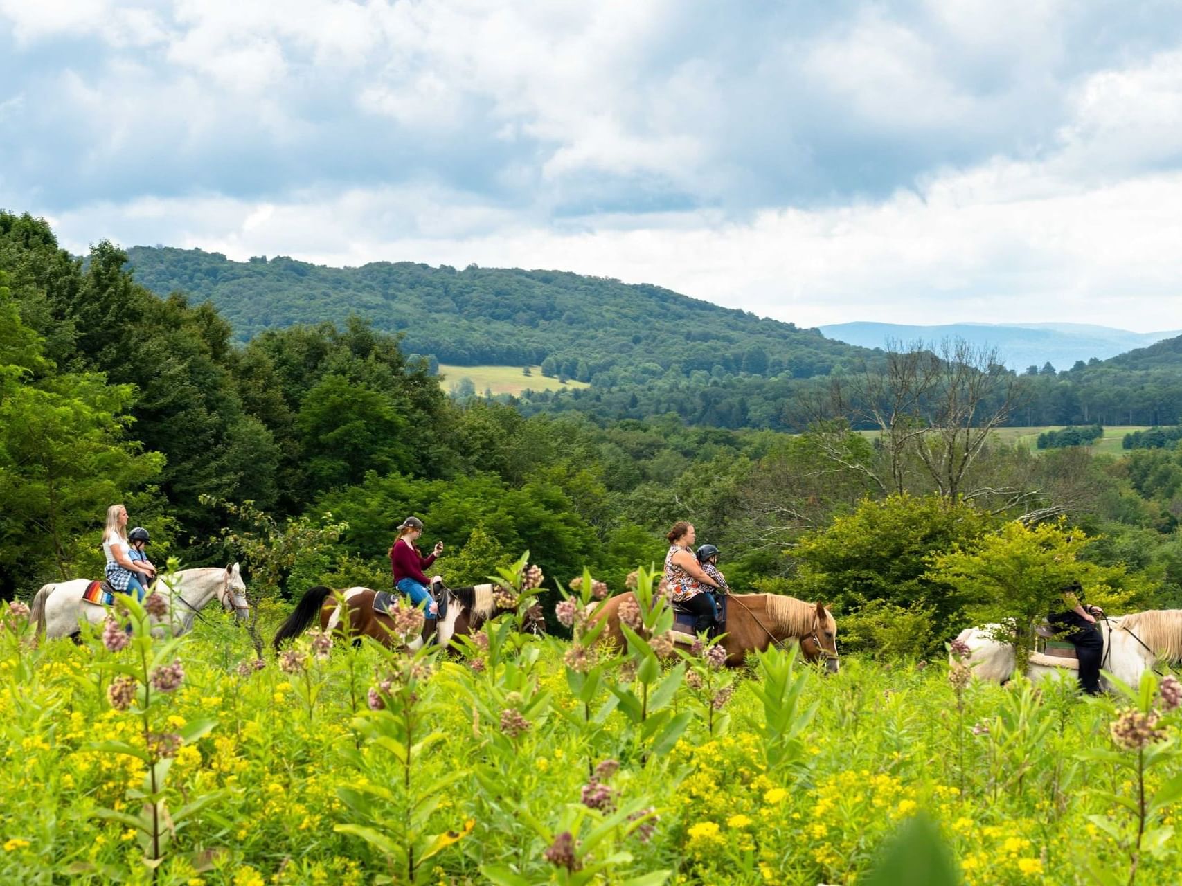 Horseback riding on a hill near The Inn at Canaan