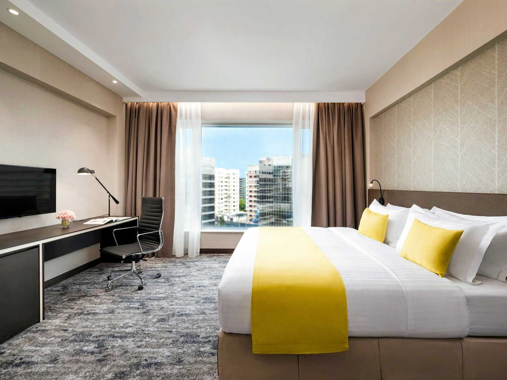 Work desk by the bed in Deluxe King Room with a city view at Park Hotel Hong Kong