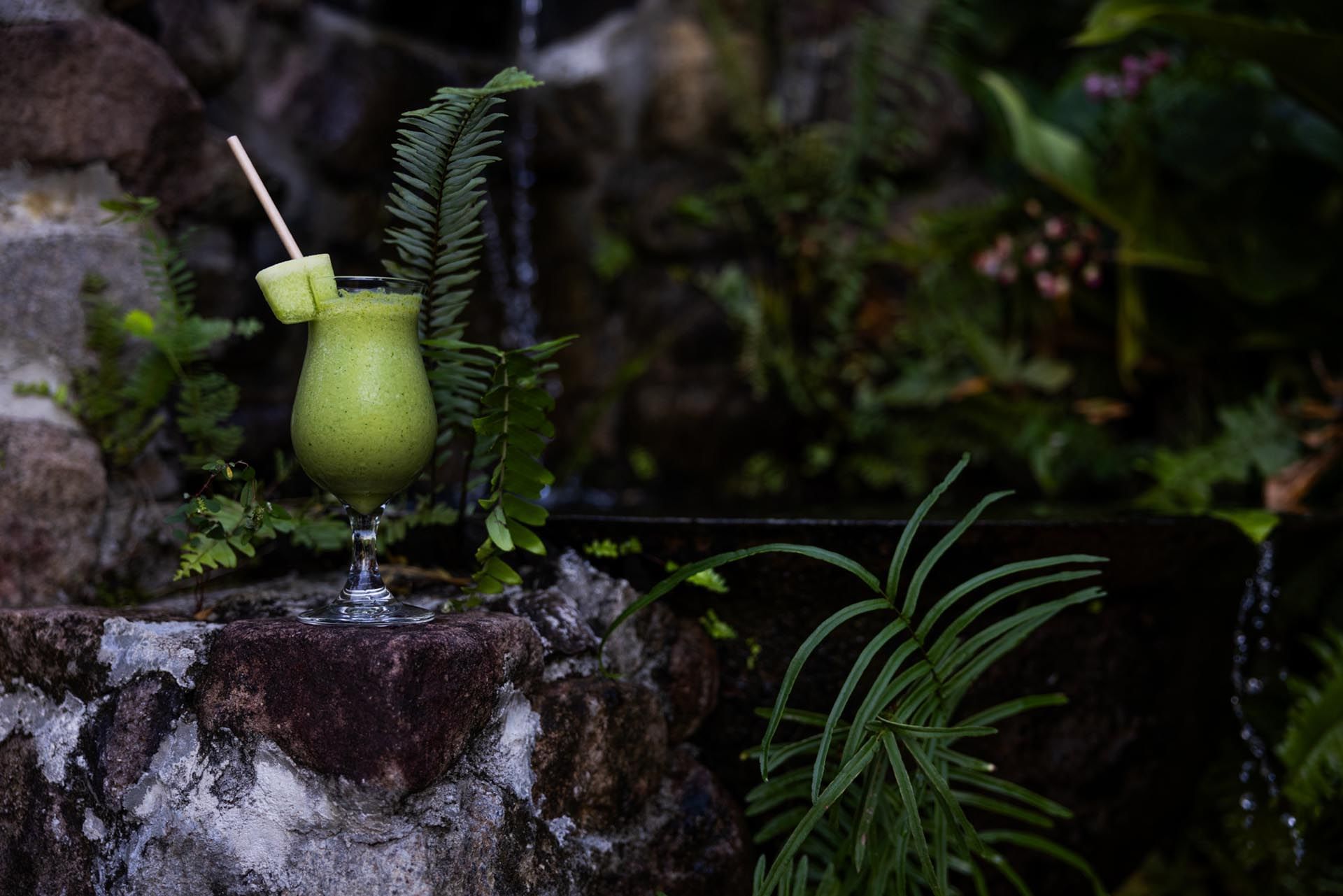 Distance view of Cucumber Smoothie served near pond at Ladera Resort, Saint Lucia