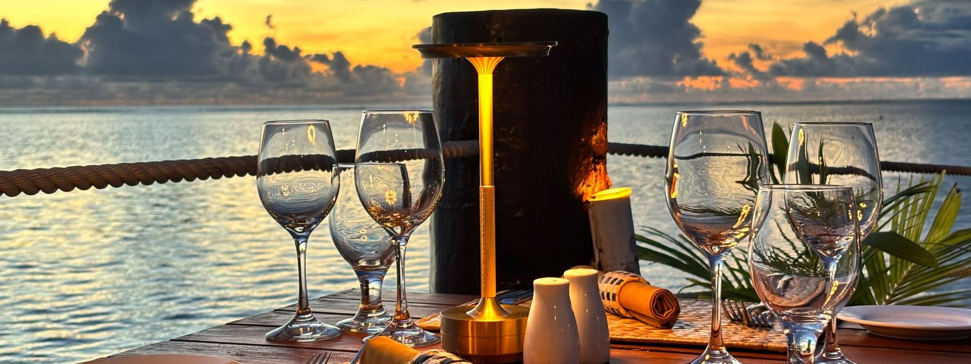 Set table with ocean view at sunset at Wicked Walu in Korolevu at Warwick Fiji Resort and Spa
