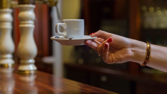 A lady hand holding a coffee at Le Logis d'Elbee