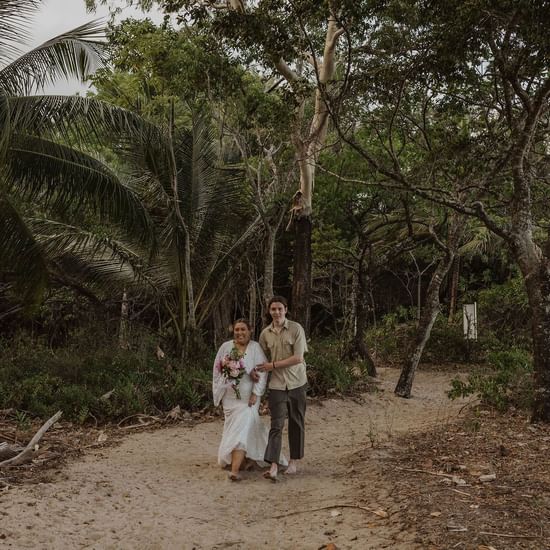 Bride walking with lady near Pullman Palm Cove Sea Resort