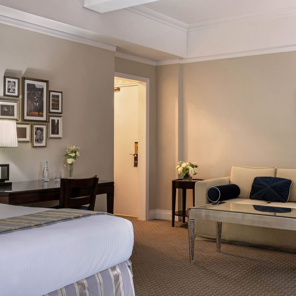 Cream sofa &, mirrored coffee table, and a dark wood desk in Premier City View with Terrace at Warwick New York 