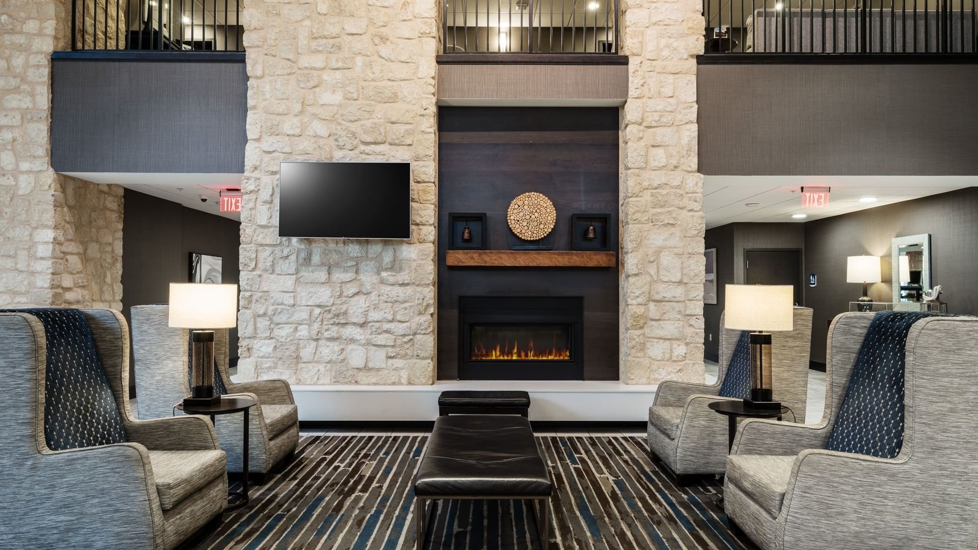 Main lobby of Shangri-La Monkey Island, featuring a stone wall, fireplace, and a TV