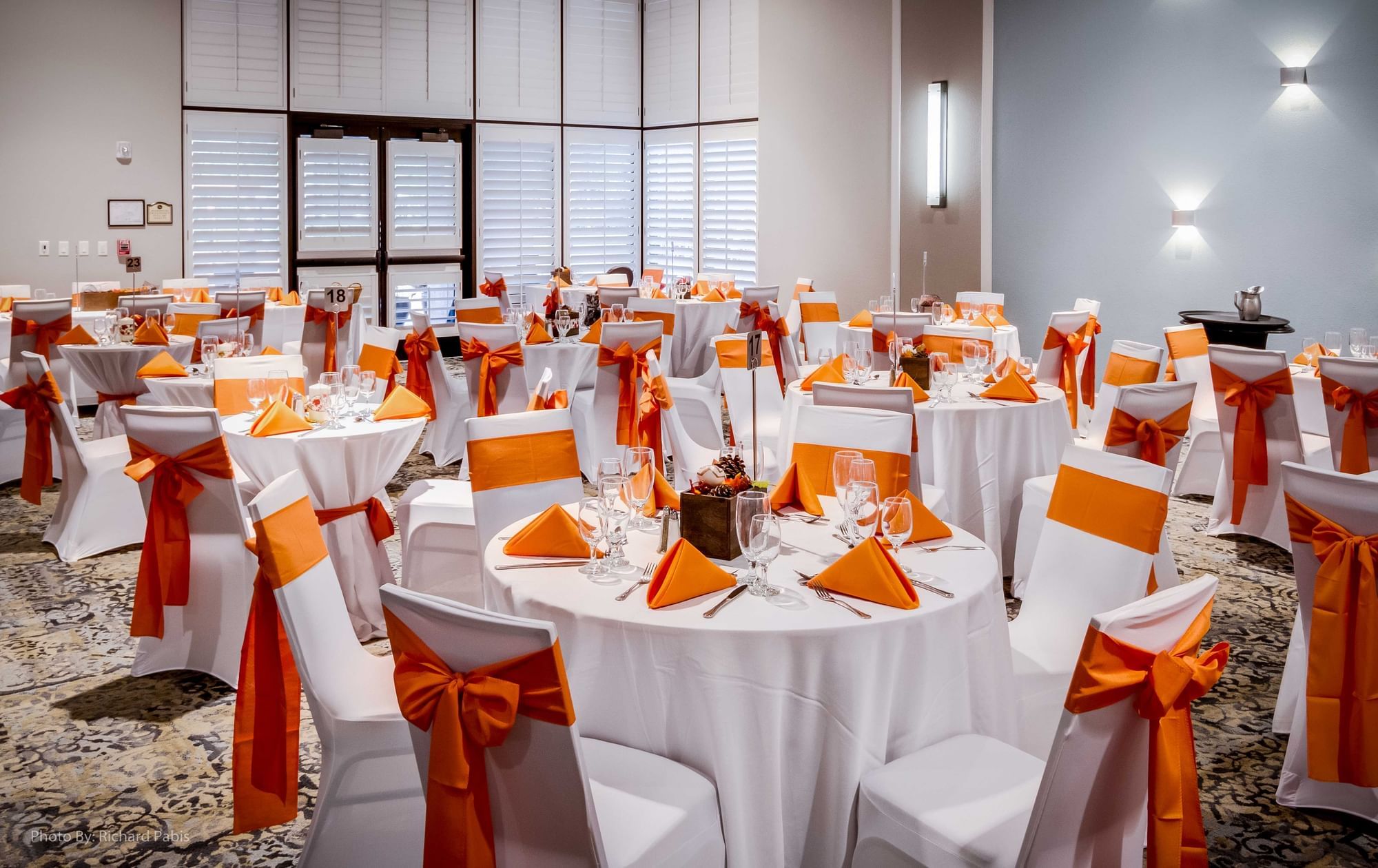 a banquet hall with round tables set for a meal